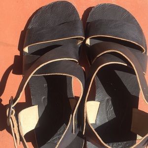 Black leather sandals.